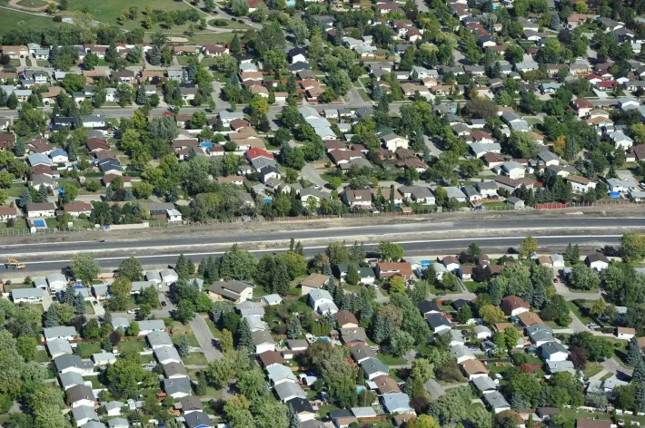 Long aerial view of construction route through residential area