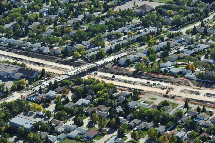 Aerial view of construction crossing through neighbourhood area